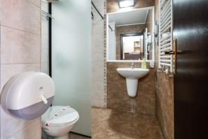 a bathroom with a toilet and a sink at Apart Hotel Dream in Bansko +127 photos