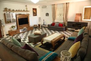 a living room with a couch and a table at Dar Elferdaous in Al Medou