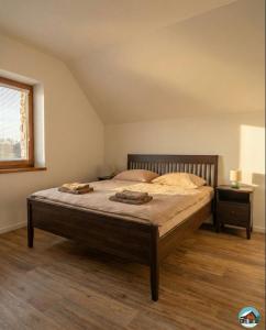 a bedroom with a large bed with two pillows on it at Chata Hrbánik Tále in Bystrá