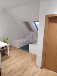 an attic room with a desk and a table at Hostel i Restoran SEQUOIA in Slatina