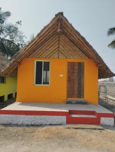 a small house with an orange at Hampi Blue Moon Resort in Munirābād