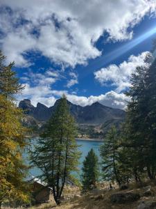 a view of a lake with trees and mountains at Riviera Lodge II in Allos