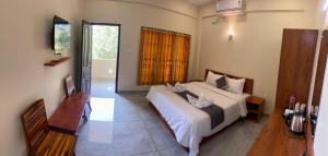 a bedroom with a large white bed in a room at Siva Bharg Residency in Kovalam