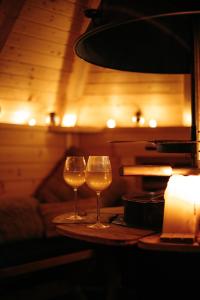 two glasses of wine sitting on a table at 4 Walkers Cottage - Cosy, dog friendly with private unique BBQ hut! in Pont Sticill
