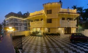 a building covered in christmas lights in a parking lot at Siva Bharg Residency in Kovalam
