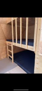 a wooden bunk bed in a wooden house at Prêt-à-camper, dôme in La Tuque