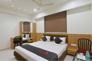 a bedroom with a large bed and a large screen at Hotel Vivanta Inn Somnath in Somnath +21 photos