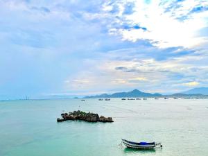a boat in the ocean with a small island in the water at NT Bell Homestay in Ninh Hải +38 photos