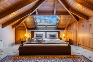 a bedroom with a large bed in a wooden house at Rigas Hotel Arachova in Arachova