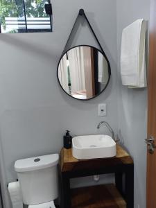 a bathroom with a sink and a mirror on the wall at Kabana Harmony in Aquidauana +53 photos