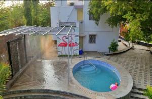 a hot tub in the middle of a yard at Arpan Villa in Aurangabad