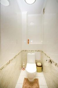 a bathroom with a white toilet in a room at Abylai Khan 113 Central in Almaty +9 photos