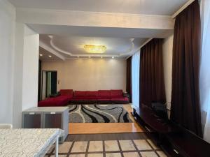 a room with a bed with red pillows in it at Abylai Khan 113 Central in Almaty
