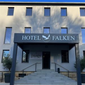 a hotel building with a sign on the front of it at Gästehaus Falken in Hechingen