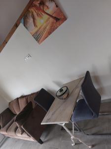 a table and chairs in a room with a couch at Chez Liliane in Bouillante