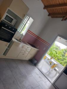 an empty kitchen with a sink and a window at Chez Liliane in Bouillante +6 photos
