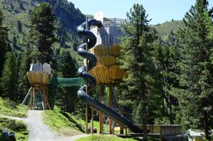 a playground in the mountains with a slide at Apartment Jerzens 1 in Jerzens