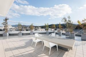 a wooden table and chairs on a roof at Experience Ise Miyamachi Hotel in Ise