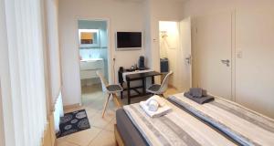 a bedroom with a bed and a table with chairs at Zimmer mit Terrasse am Jakobsberg in Ockenheim