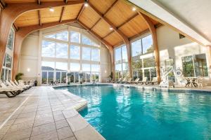an indoor swimming pool with a large building with windows at Vacation Village in the Berkshires in Hancock