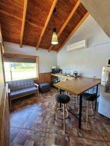 a kitchen with a table and chairs and a couch at Aysen Bike Cabañas in Puerto Aisén