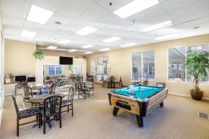 a pool table in a room with tables and chairs at Vacation Village in the Berkshires in Hancock