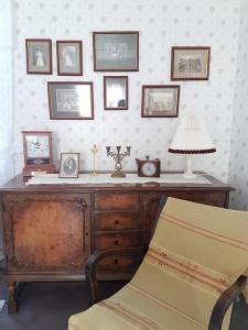 a room with a desk with a lamp and pictures on the wall at Sundholms Gård - Sundholmin Tila in Kokkola