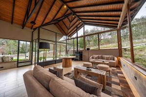 a living room with a couch and a table at Altos Ushuaia Hotel & Resto in Ushuaia