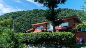 a house with a mountain in the background at Yangpyeong Narinsoom Private Villa in Yangpyeong