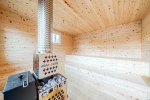 a sauna with a stove in a wooden room at Yangpyeong Narinsoom Private Villa in Yangpyeong +16 photos