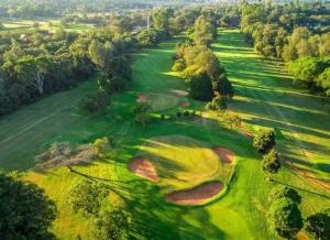 an aerial view of a golf course with a green at The Paradise Inn Kilimanjaro in Moshi