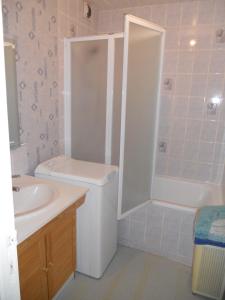 a bathroom with a shower and a toilet and a sink at Cocon Marin 2 Etoiles - Face Océan et Balcon in Fort-Mahon-Plage