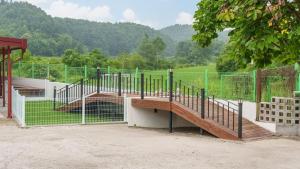 a gate with a wooden ramp and a fence at Gapyeong Nature Pension in Gapyeong