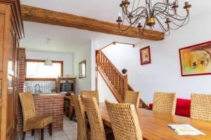 a dining room with a wooden table and chairs at Maison familiale quartier Quentovic in Le Touquet-Paris-Plage