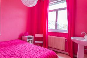 a pink bedroom with a bed and a sink at Maison familiale quartier Quentovic in Le Touquet-Paris-Plage
