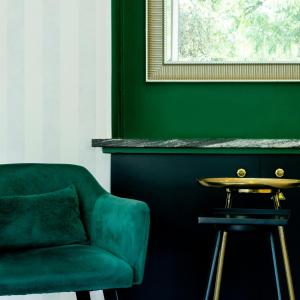 a green chair and a table in a room at Hotel Aria in Nice