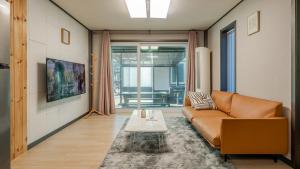 a living room with a couch and a table at Hongcheon Pension 150 in Hongcheon