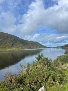 a view of a lake with mountains in the background at Connemara sea side house, dog paradise! in Leagaun