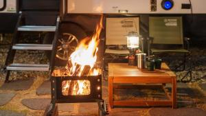 a fire pit in front of a camper at Sokcho Supuro Caravan in Sokcho +12 photos