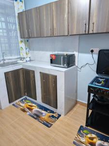a kitchen with a counter with a microwave on it at Tulivu 2 stays in Nyahururu