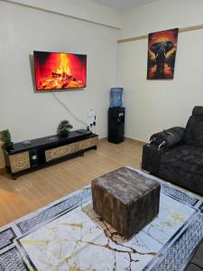 a living room with a couch and a fireplace at Tulivu 2 stays in Nyahururu