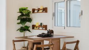 a table and chairs in a room with a window at Yeongheungdo Stay Noc Pool Villa in Incheon
