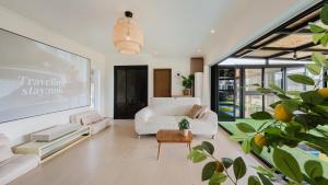 a living room with a white couch and a table at Yeongheungdo Stay Noc Pool Villa in Incheon
