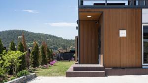 a building with the door open in a garden at Yeongheungdo Stay Noc Pool Villa in Incheon