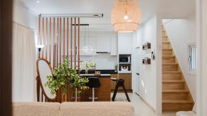 a living room with a couch and a kitchen at Yeongheungdo Stay Noc Pool Villa in Incheon