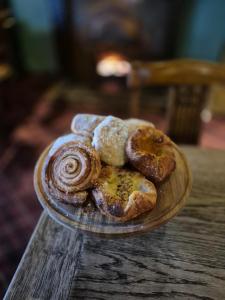 a plate of pastries on a wooden table at Robin Hood Inn in Wall Houses