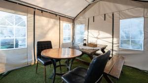 a room with a table and chairs in a tent at Ganghwado Babavelley Pension in Incheon