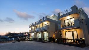 a large white building with a lot of windows at Ganghwado Babavelley Pension in Incheon