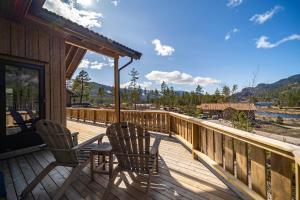 a wooden deck with two chairs and a table on it at Sigr Hytte 8p With Sauna in Vradal