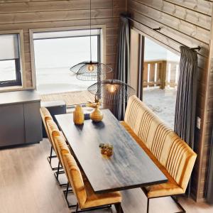 a dining room with a table and chairs and a window at Sigr Hytte 8p With Sauna in Vradal